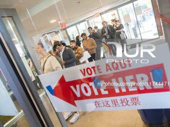 Voters stand in line at a local polling station in Washington, DC, on November 5, 2024. Americans cast their ballots in the presidential rac...