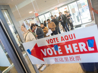 Voters stand in line at a local polling station in Washington, DC, on November 5, 2024. Americans cast their ballots in the presidential rac...