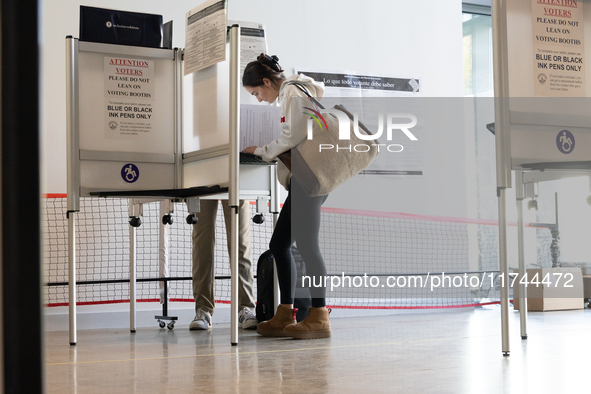 Voters stand in line at a local polling station in Washington, DC, on November 5, 2024. Americans cast their ballots in the presidential rac...