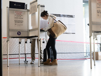 Voters stand in line at a local polling station in Washington, DC, on November 5, 2024. Americans cast their ballots in the presidential rac...