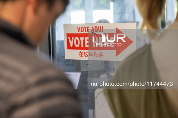 Voters stand in line at a local polling station in Washington, DC, on November 5, 2024. Americans cast their ballots in the presidential rac...