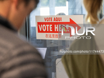 Voters stand in line at a local polling station in Washington, DC, on November 5, 2024. Americans cast their ballots in the presidential rac...