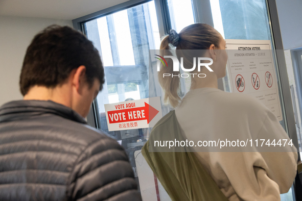 Voters stand in line at a local polling station in Washington, DC, on November 5, 2024. Americans cast their ballots in the presidential rac...