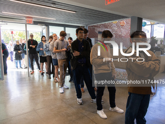 Voters stand in line at a local polling station in Washington, DC, on November 5, 2024. Americans cast their ballots in the presidential rac...