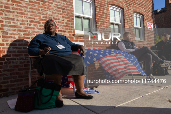 Voters stand in line at a local polling station in Washington, DC, on November 5, 2024. Americans cast their ballots in the presidential rac...