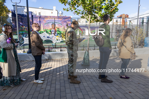 Voters stand in line at a local polling station in Washington, DC, on November 5, 2024. Americans cast their ballots in the presidential rac...