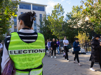 Voters stand in line at a local polling station in Washington, DC, on November 5, 2024. Americans cast their ballots in the presidential rac...