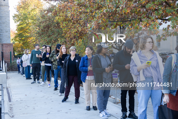 Voters stand in line at a local polling station in Washington, DC, on November 5, 2024. Americans cast their ballots in the presidential rac...