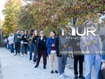 Voters stand in line at a local polling station in Washington, DC, on November 5, 2024. Americans cast their ballots in the presidential rac...