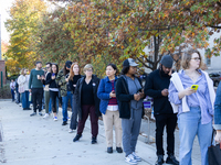 Voters stand in line at a local polling station in Washington, DC, on November 5, 2024. Americans cast their ballots in the presidential rac...