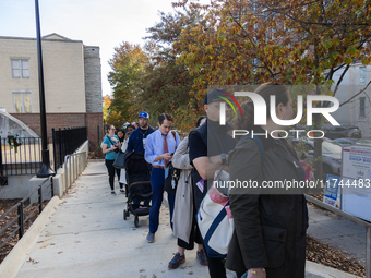 Voters stand in line at a local polling station in Washington, DC, on November 5, 2024. Americans cast their ballots in the presidential rac...