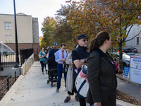 Voters stand in line at a local polling station in Washington, DC, on November 5, 2024. Americans cast their ballots in the presidential rac...