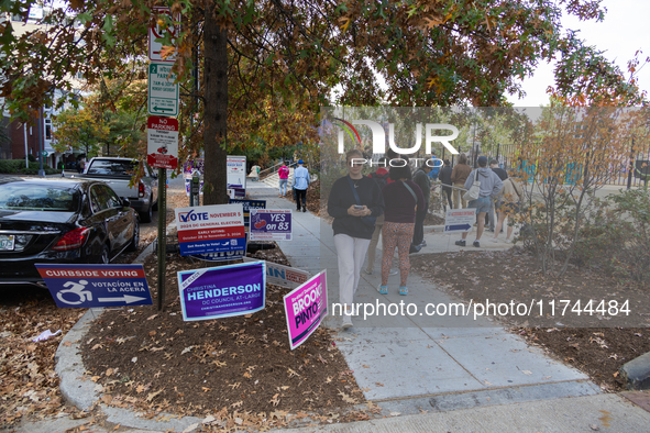 Voters stand in line at a local polling station in Washington, DC, on November 5, 2024. Americans cast their ballots in the presidential rac...