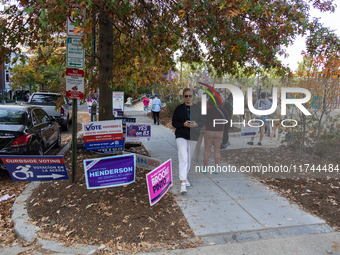 Voters stand in line at a local polling station in Washington, DC, on November 5, 2024. Americans cast their ballots in the presidential rac...