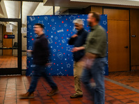 People walk past an election-themed display banner inside the Hennepin County Government Center in Minneapolis, Minnesota, on November 5, 20...