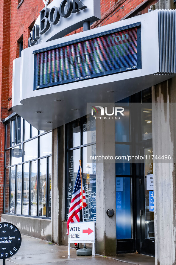 Signs and banners indicate a polling location for voters at the Minnesota Book Arts Center on Election Day 2024 in Minneapolis, Minnesota, o...