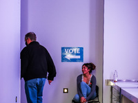 A voter walks past an election official to vote at a polling location inside the Guthrie Theatre in Minneapolis, Minnesota, on November 5, 2...