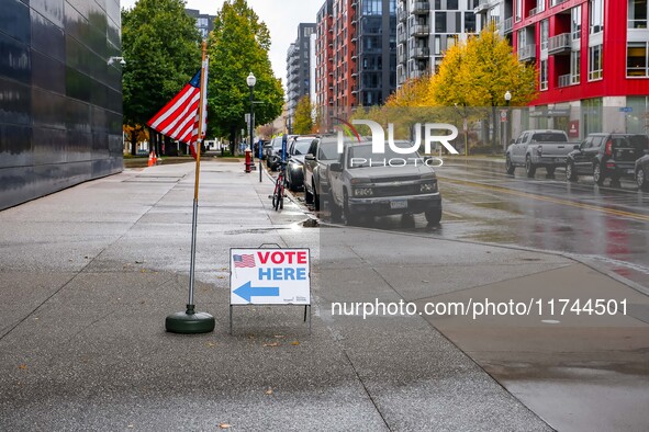 A sign and flag indicating a polling place for voters are seen next to the Guthrie Theatre on Election Day 2024 in Minneapolis, Minnesota, o...