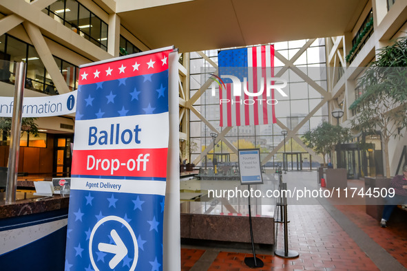 A sign points to a ballot drop-off location within the Hennepin County Government Center on Election Day 2024 in Minneapolis, Minnesota, on...