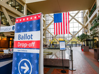 A sign points to a ballot drop-off location within the Hennepin County Government Center on Election Day 2024 in Minneapolis, Minnesota, on...