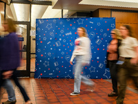 People walk past an election-themed display banner inside the Hennepin County Government Center in Minneapolis, Minnesota, on November 5, 20...