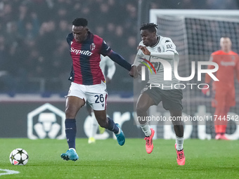 Jhon Lucumi of Bologna FC and Wilfried Singo of AS Monaco compete for the ball during the UEFA Champions League 2024/25 League Phase MD4 mat...