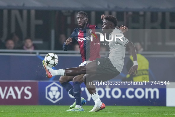 Christian Mawissa of AS Monaco andSamuel Iling-Junior of Bologna FC compete for the ball during the UEFA Champions League 2024/25 League Pha...