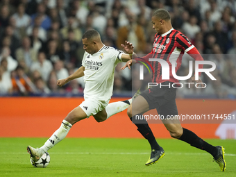 Kylian Mbappe centre-forward of Real Madrid and France shooting to goal front Malick Thiaw centre-back of AC Milan and Germany during the UE...