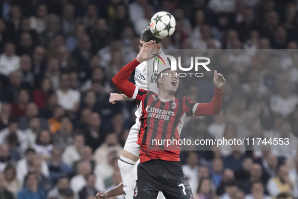 Federico Valverde of Real Madrid and Alvaro Morata of AC Milan fight for the ball during the UEFA Champions League 2024/25 match between Rea...