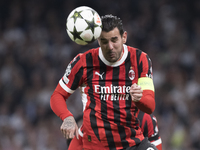 Theo Hernandez of AC Milan is in action during the UEFA Champions League 2024/25 match between Real Madrid and AC Milan at Santiago Bernabeu...