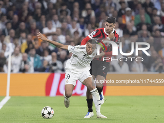 In Madrid, Spain, on November 5, Kylian Mbappe of Real Madrid and Alvaro Morata of AC Milan fight for the ball during the UEFA Champions Lea...