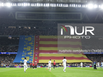 A Valencia flag is displayed at the Santiago Bernabeu Stadium in Madrid, Spain, on November 5, in memory of those who died in the Valencia f...