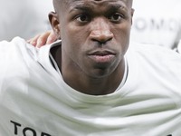 Vinicius Jr of Real Madrid shows a t-shirt supporting Valencia during the UEFA Champions League 2024/25 match between Real Madrid and AC Mil...