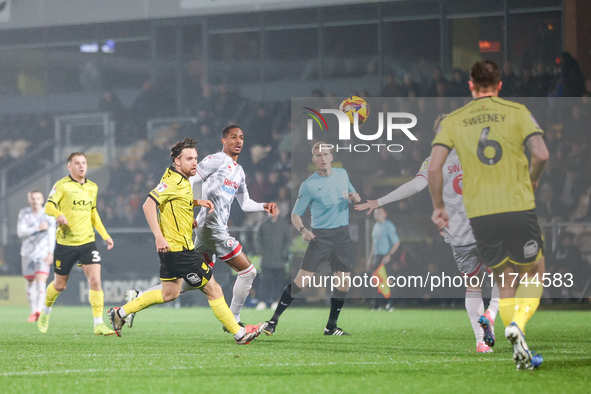 Elliot Watt of Burton Albion and Joy Mukena of Crawley Town race after the ball during the Sky Bet League 1 match between Burton Albion and...