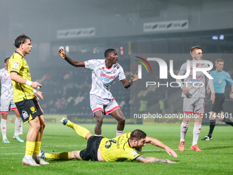 #12, Panutche Camara of Crawley Town (center) attempts a shot on goal during the Sky Bet League 1 match between Burton Albion and Crawley To...