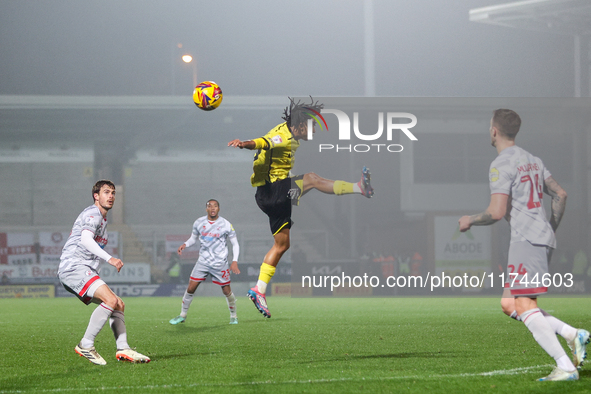 Romelle Donovan of Burton Albion goes airborne as he attempts to clear the ball during the Sky Bet League 1 match between Burton Albion and...