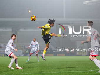 Romelle Donovan of Burton Albion goes airborne as he attempts to clear the ball during the Sky Bet League 1 match between Burton Albion and...