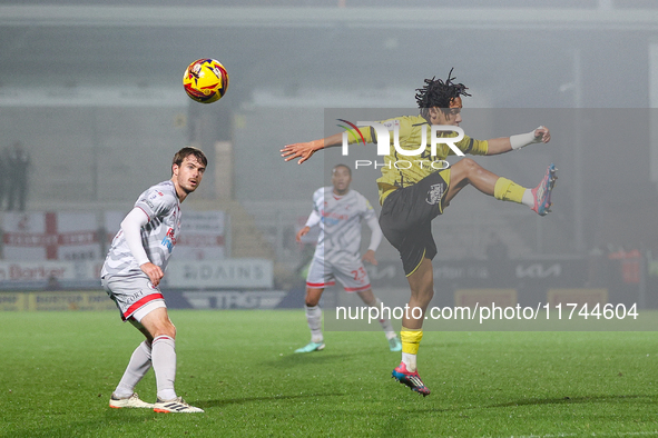 Romelle Donovan of Burton Albion goes airborne as he attempts to clear the ball during the Sky Bet League 1 match between Burton Albion and...