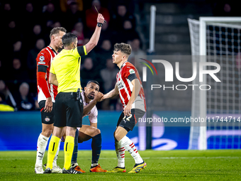 PSV Eindhoven defender Matteo Dams receives a yellow card during the match between PSV and Girona at the Philips Stadium for the UEFA Champi...