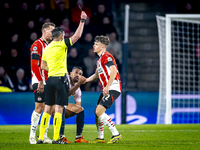 PSV Eindhoven defender Matteo Dams receives a yellow card during the match between PSV and Girona at the Philips Stadium for the UEFA Champi...