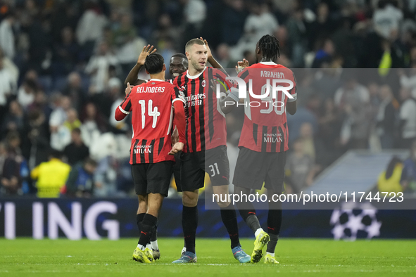 Milan players celebrate victory after the UEFA Champions League 2024/25 League Phase MD4 match between Real Madrid C.F. and AC Milan at Esta...