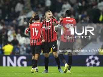 Milan players celebrate victory after the UEFA Champions League 2024/25 League Phase MD4 match between Real Madrid C.F. and AC Milan at Esta...