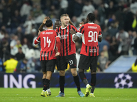 Milan players celebrate victory after the UEFA Champions League 2024/25 League Phase MD4 match between Real Madrid C.F. and AC Milan at Esta...