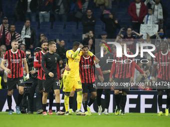 Milan players celebrate victory after the UEFA Champions League 2024/25 League Phase MD4 match between Real Madrid C.F. and AC Milan at Esta...