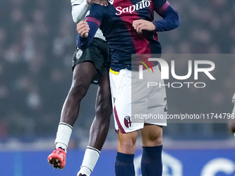 Thijs Dallinga of Bologna FC and Wilfried Singo of AS Monaco jump for the ball during the UEFA Champions League 2024/25 League Phase MD4 mat...