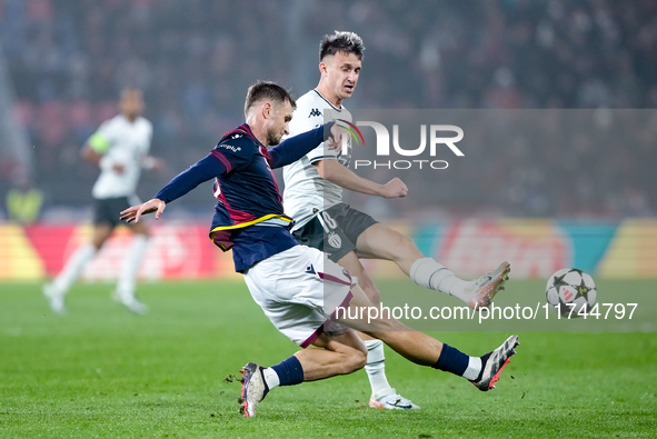 Stefan Posch of Bologna FC and Aleksandr Golovin of AS Monaco compete for the ball during the UEFA Champions League 2024/25 League Phase MD4...