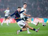 Stefan Posch of Bologna FC and Aleksandr Golovin of AS Monaco compete for the ball during the UEFA Champions League 2024/25 League Phase MD4...