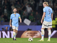 Erling Haaland (right) and Bernardo Silva (left) of Manchester City react after Maxi Araujo of Sporting CP (not in frame) scores his team's...