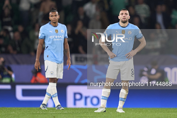 Mateo Kovacic (right) and Manuel Akanji (left) of Manchester City react after Maxi Araujo of Sporting CP scores his team's second goal durin...