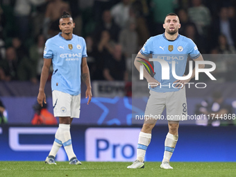 Mateo Kovacic (right) and Manuel Akanji (left) of Manchester City react after Maxi Araujo of Sporting CP scores his team's second goal durin...